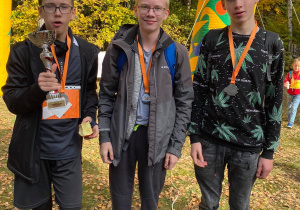 Trzech chłopców trzymający puchar