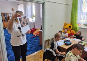 Pani pokazuje zdjęcie autorki ksiażki.