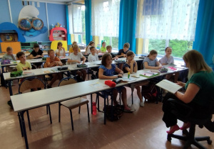 Pani czyta dzieciom przed wakacjami legendę "Dlaczego woda morska jest słona?"