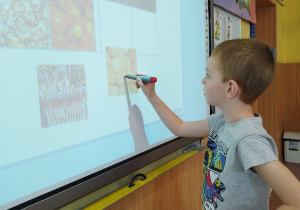 Uczeń klasy I B przy tablicy dotykowej