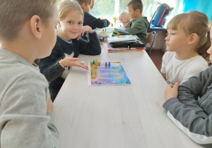 Uczniowie grają w grupach.
