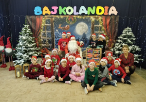 Uczniowie klasy pierwszej pozują do zdjęcia z Mikołajem.