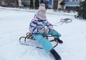 Uczeń klasy 3 B zjeżdża na sankach z górki