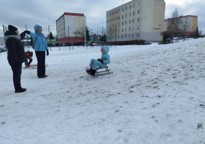 Uczennica klasy 3 B zjeżdża na sankach z górki