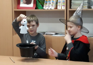 Dwaj koledzy prezentują magiczne sztuczki.