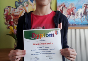 Uczennica klasy III b Kinga Świątkiewicz prezentuje dyplom za zajęcie drugiego miejsca.
