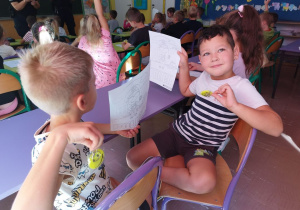 Dzieci pokazują znaczki i obrazki.