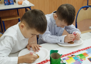 Dzieci ozdabiają pierniczki kolorowym lukrem