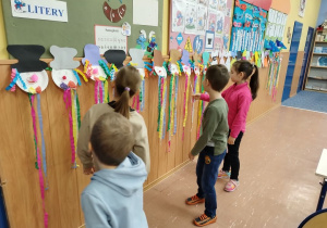 Uczniowie ogladaja prace w klasowej galerii